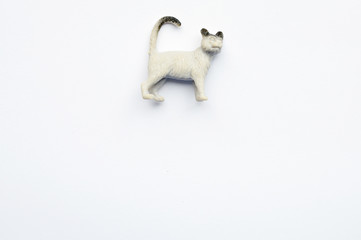 Figurine of a cat on white background