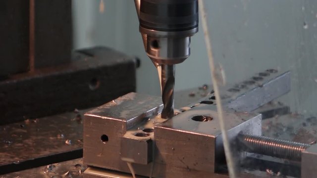 drilling holes in the drilling machine