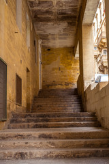street with traditional balconies and old buildings in historical city Valletta Malta