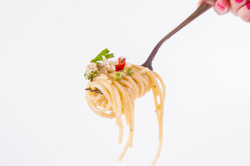 Spaghetti with cream sauce with smoked mackerel, peas ,bell pepper and some parsley eaten with a fork