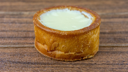 Japanese cheese baked tart on wooden background.