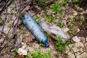Plastic debris is lying on the ground.