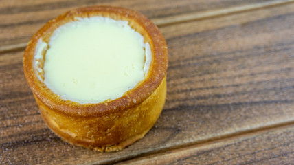 Japanese cheese baked tart on wooden background.