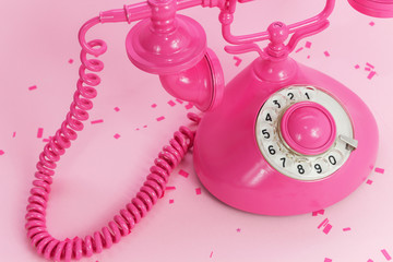 Pink vintage telephone on a pink background. Place for text. Minimalism. Concept. Texture Background