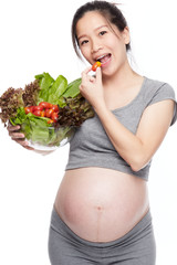 A portrait of a Happy pregnant woman with a bowl of salad