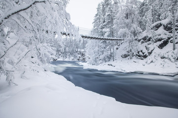 Scenic winter landscape view with flowing river and snow covered trees