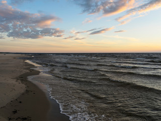 Fototapeta na wymiar dramatic sunset, seashore, strong winds and blurred waves, beautiful and colorful skies, dusk