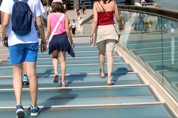 family walks on the modern bridge in Venice Italy called Ponte d