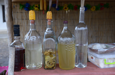 Bottles with traditional Ukrainian drink “samogon” sealed in traditional way and placed on a...