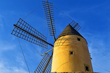 Begind an old windmill on background of blue sky, Santa Ponca, Majorca, Spain