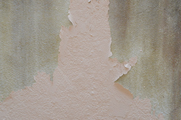 The old cement walls were stained. Beautiful colors layers of an outdoor plaster wall showing...