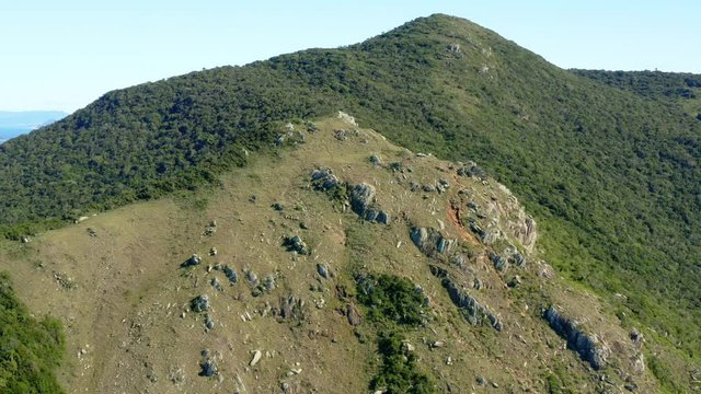 Morro Da Coroa summit establishing aerial shot at Lagoinha Do Leste beach, Florianopolis, Santa Catarina, Brazil