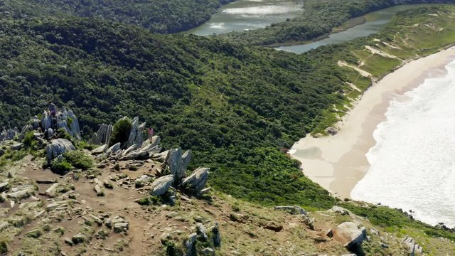 Morro Da Coroa summit circling aerial cinematic shot at Lagoinha Do Leste beach, Florianopolis, Santa Catarina, Brazil