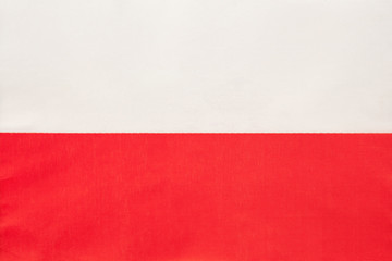 Poland national fabric flag, textile background. Symbol of international world european country.