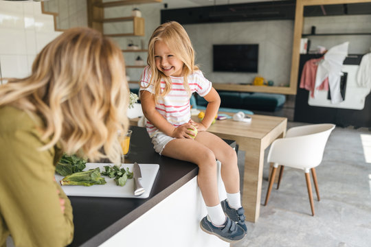 Happy kid with apple laughing stock photo