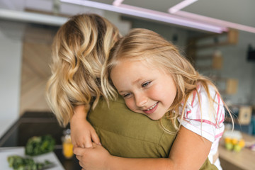 Smiling girl in arms of mom stock photo