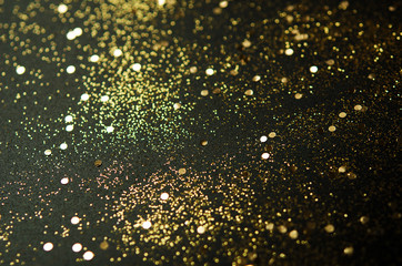 Golden sparkles on black background. Festive concept. - Image