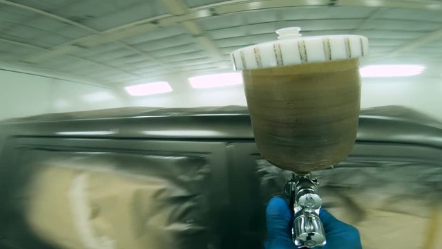 Automobile's body is being spray-painted