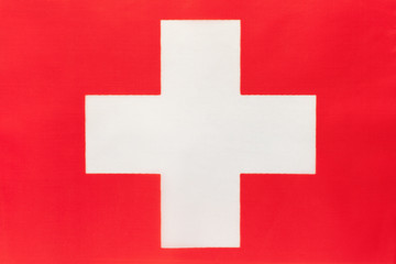 Switzerland national fabric flag, textile background. Symbol of international world european country.