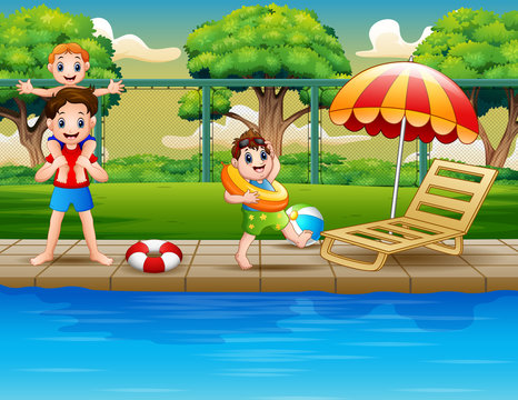 Happy boys enjoying playing in outdoor pool