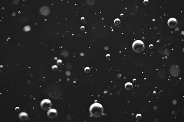 Bubbles of oxygen or air in a dark liquid. For projects with liquid or oil. Macro