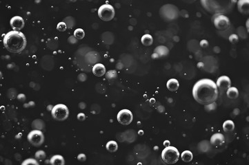 Bubbles of oxygen or air in a dark liquid. For projects with liquid or oil. Macro