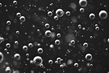 Bubbles of oxygen or air in a dark liquid. For projects with liquid or oil. Macro
