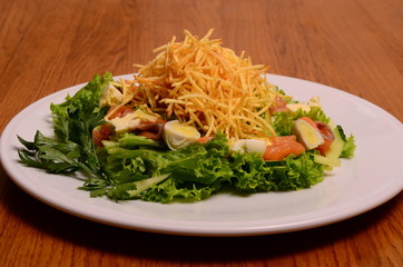 Ethical vegetarian or vegan meal. Boiled quail eggs in a spiralized fried potato french fries nest, Served with baby leaf salad. Healthy low calorie slimmer's meal made with a spiralizer.