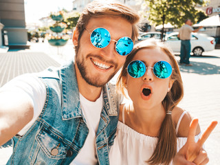 Smiling beautiful girl and her handsome boyfriend in casual summer clothes.Happy family taking...