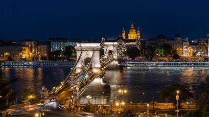 Budapest, Hungary, night view of the Basilica of St Stephen and Chain Bridge over the Danube river.