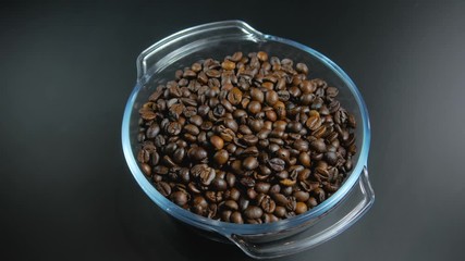 Roasted coffee beans in a glass jar.