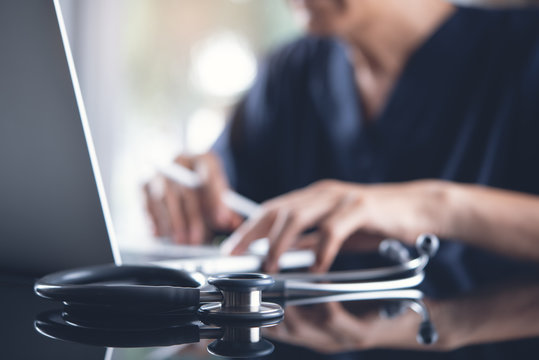 Doctor Working On Laptop Computer