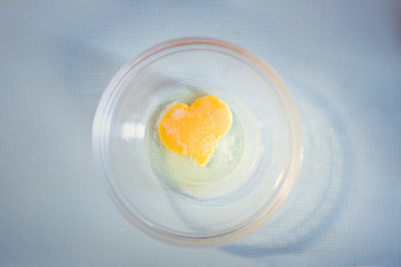egg yolk heart in a glass bowl