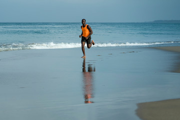 athletic full body portrait of young attractive and fit black African American man running on the...