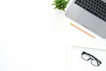 Creative flat lay photo of workspace desk. Top view office desk with laptop, glasses, pencil and...