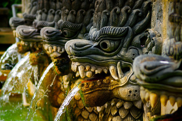 stone fountain carved with statue of Barong in hindu temple in Bali-Indonesia