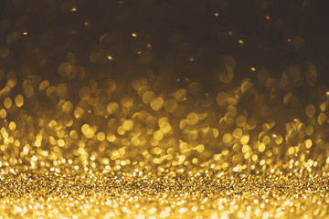 Gold glitter sparkle lights background. Defocused glitter abstract twinkly light and shiny stars....