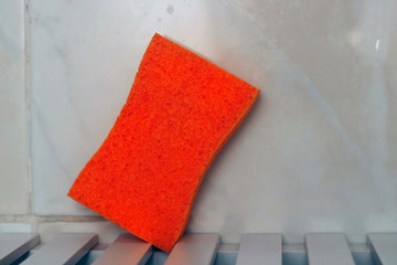 Sponge on a table in the sink.