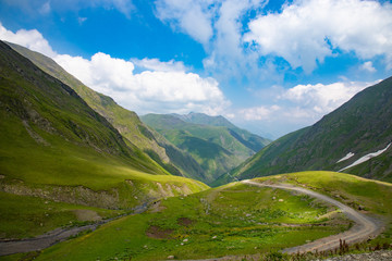 Fototapeta na wymiar Mountain landscape, beautiful green mountain road blue sky, Abano pass, Tusheti, Georgia