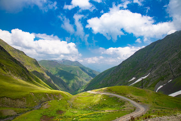 Fototapeta na wymiar Mountain landscape, beautiful green mountain road blue sky, Abano pass, Tusheti, Georgia
