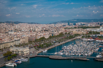 Fototapeta premium BARCELONA, SPAIN - SEPTEMBER 9, 2014: Aerial view of Barcelona from the cableway to the Montjuic hill with the Barceloneta beach and Port Vell. Catalonia, Spain, Europe
