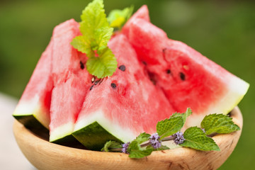 Delicious watermelon slices on wooden plate