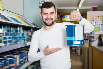 Young male is deciding on best wall paint