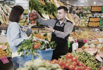 Male seller assisting in buying