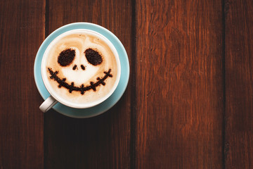 Cup of coffee with scary Jack's face. Halloween background. Halloween party. 