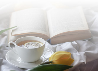 mug of hot tea and book
