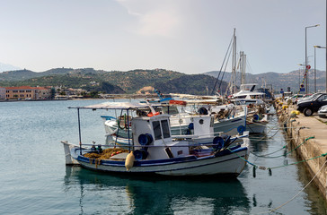 Fototapeta na wymiar Moored fishing ships on the waterfront close-up (Greece, Peloponnese)
