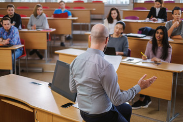 Lecturer and multinational group of students in an auditorium