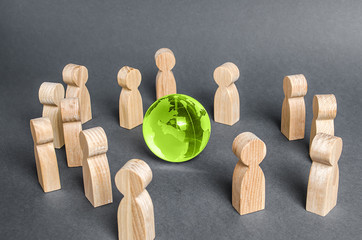People surrounded a glass globe. cooperation and collaboration of people around the world....