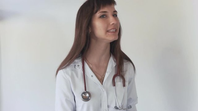 Young doctor woman warning you about a bad habit. Doctor in medical masks haking her finger.